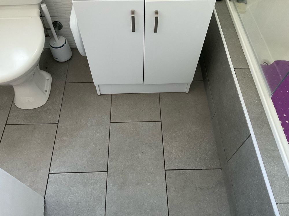 Loose tiles in a bathroom, found during a pre-purchase inspection in Newport